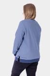 Back view of a woman wearing the Dovetail Workwear GO TO™ Crew Sweatshirt in Slate Blue/Atlantic Blue, showing the relaxed fit and Dovetail graphic at the hem