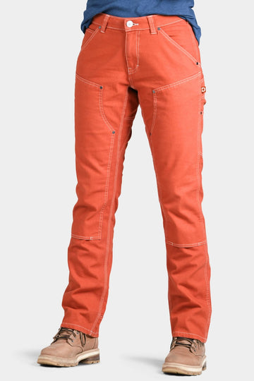 Anna Taskpant in Paprika Canvas by Dovetail Workwear displayed on a woman wearing tan boots, featuring reinforced knees, nested pockets, and contrast stitching