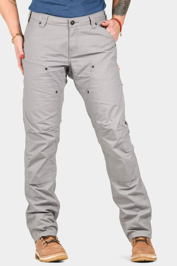 Anna Ultralight Trail Pant in Dove Grey Ripstop by Dovetail Workwear, shown from the front on a woman wearing a blue shirt and tan boots, featuring reinforced knees and nested pockets