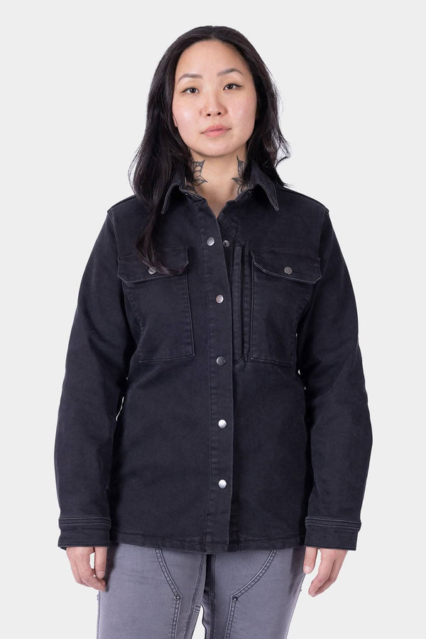 Black Oahe HOTSWAP™ Thermal Denim Work Jacket by Dovetail Workwear with reinforced elbows and multiple pockets, worn by a woman against a neutral background