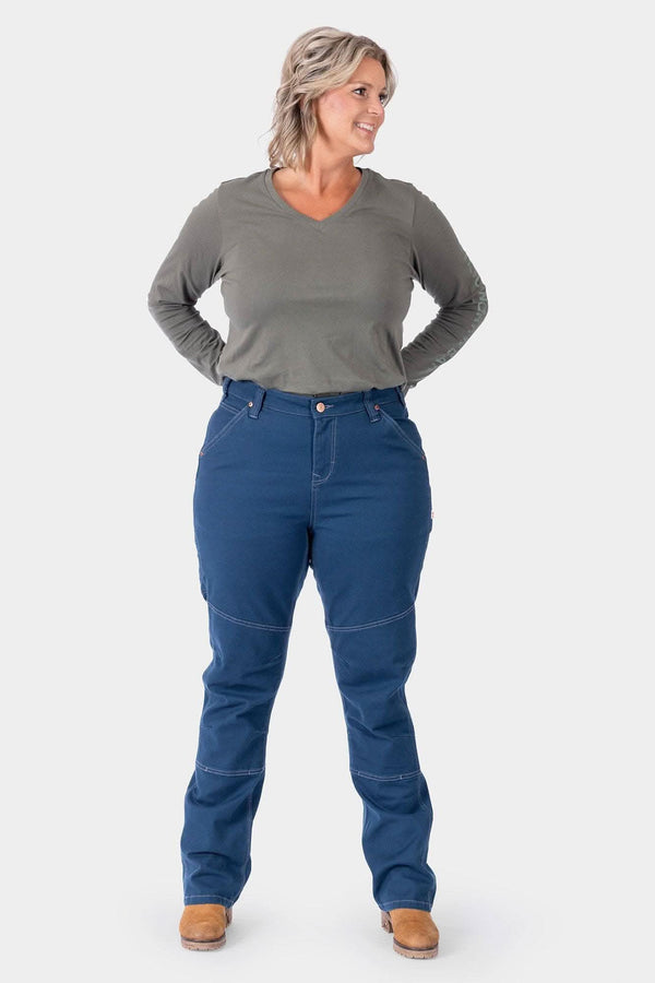 Woman wearing Dovetail Workwear GO TO™ Stretch Canvas Pant in Atlantic Blue with gray long-sleeve top, showing reinforced knees and straight leg fit