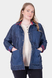 Woman wearing the Dovetail Workwear Durham Reversible Quilted Shirt Jac in Loden Green Plaid with Barn Red Plaid lining visible at collar and cuffs, hands in pockets