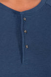 Detail view of the Honed Long Sleeve Thermal Henley in Atlantic Blue, showing the button front placket and waffle knit thermal fabric on a woman
