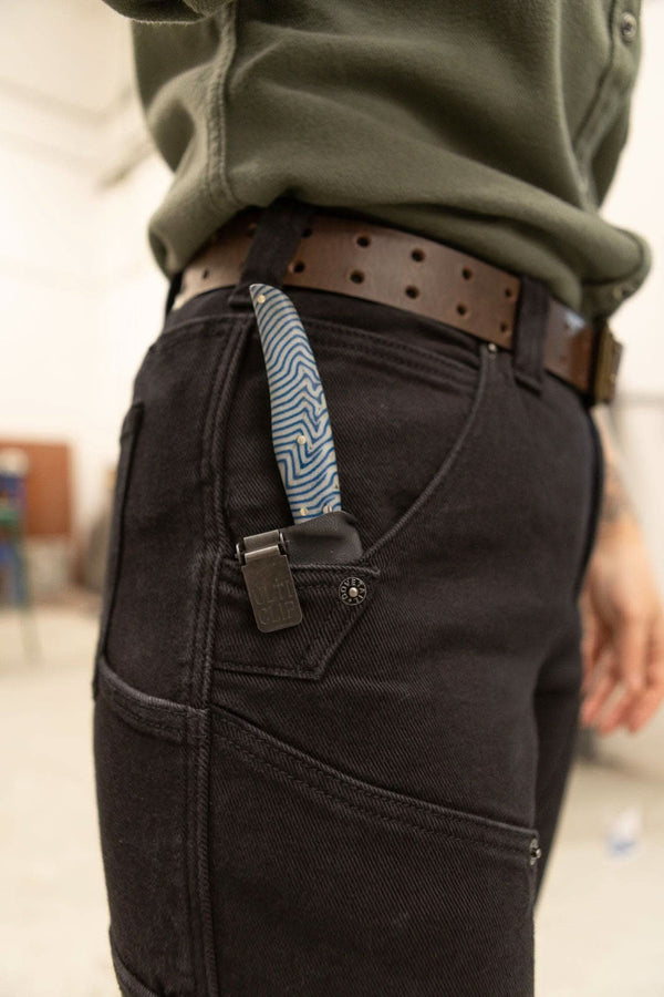 Detail shot of the Maven X Graphene Denim Pant in Black by Dovetail Workwear, highlighting the tool loop and reinforced pocket construction on a woman