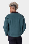 Back view of woman wearing the Lodge Green Old School Trucker Canvas Work Jacket by Dovetail Workwear, showing corduroy collar and reinforced elbow construction