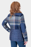 Back view of a woman wearing the Dovetail Workwear Durham Reversible Quilted Shirt Jac in Loden Green Plaid with quilted side panels and reinforced shoulders