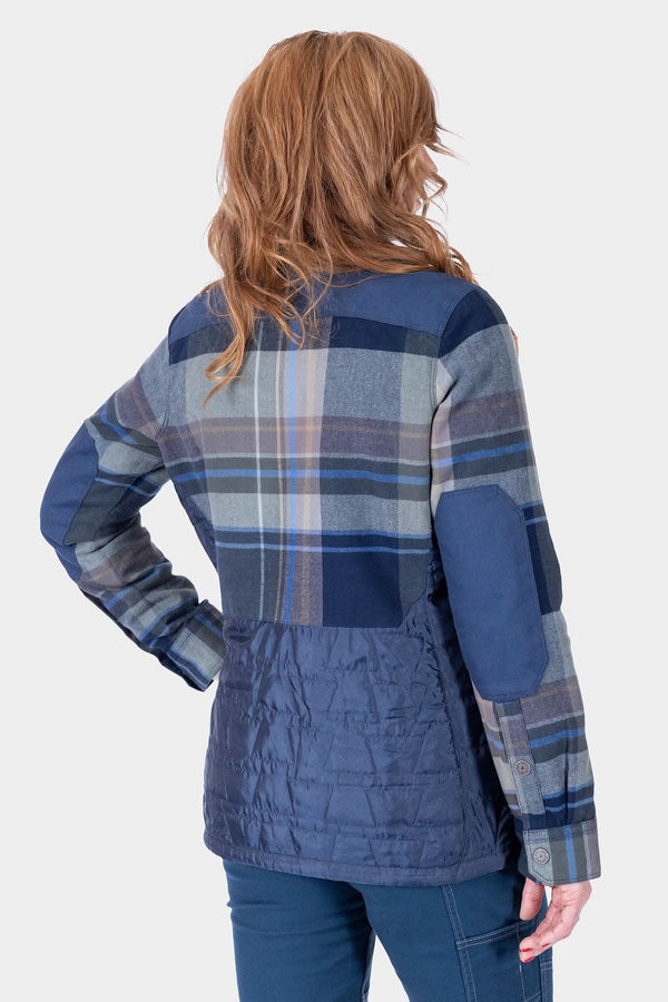 Back view of a woman wearing the Dovetail Workwear Durham Reversible Quilted Shirt Jac in Loden Green Plaid with quilted side panels and reinforced shoulders