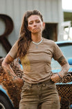 Rae Ripple x Dovetail Workwear You Will Be Art T-Shirt in Alloy Brown displayed on a woman wearing relaxed-fit, 100% cotton tee with left sleeve design in an industrial setting