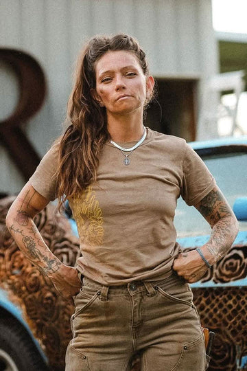Rae Ripple x Dovetail Workwear You Will Be Art T-Shirt in Alloy Brown displayed on a woman wearing relaxed-fit, 100% cotton tee with left sleeve design in an industrial setting