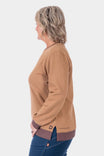 Side view of a woman wearing the Dovetail Workwear GO TO™ Crew Sweatshirt in Saddle Brown/Kodiak Brown, paired with dark denim jeans