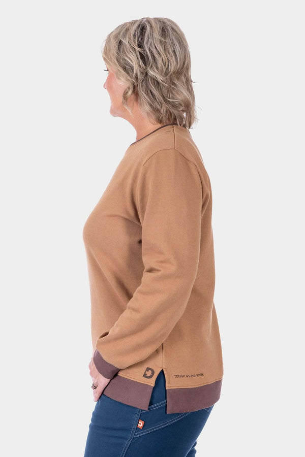 Side view of a woman wearing the Dovetail Workwear GO TO™ Crew Sweatshirt in Saddle Brown/Kodiak Brown, paired with dark denim jeans