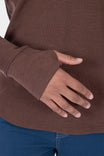 Kodiak Brown Honed Long Sleeve Thermal Henley by Dovetail Workwear worn by a woman, showing the thumbhole detail and waffle knit fabric up close