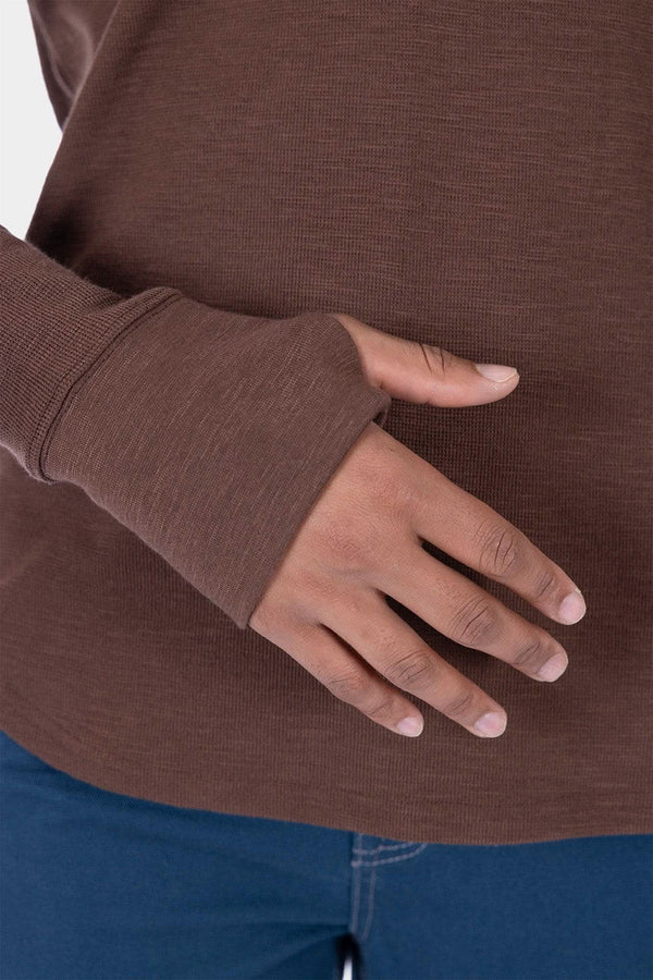 Kodiak Brown Honed Long Sleeve Thermal Henley by Dovetail Workwear worn by a woman, showing the thumbhole detail and waffle knit fabric up close