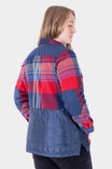 Back view of a woman wearing the Dovetail Workwear Durham Reversible Quilted Shirt Jac in Barn Red Plaid, showing the quilted side with reinforced shoulders and elbow panels