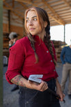 Barn Red Givens Stretch Chamois Work Shirt by Dovetail Workwear worn by a woman with braided hair, featuring buttoned chest pocket and pencil pocket on sleeve