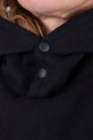 Detail view of the Carbon Black GO TO™ Hoodie by Dovetail Workwear showing snap closure at the neck on a woman wearing the hoodie