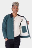 Dovetail Workwear Old School Trucker Canvas Work Jacket in Lodge Green displayed open, showing faux shearling lining and chest pocket detail on a woman