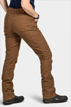 Back view of a woman wearing the Britt Utility Pant in Saddle Brown Canvas by Dovetail Workwear, showcasing nested pockets, tool loop, and straight leg fit