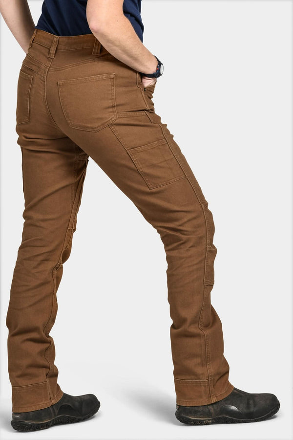 Back view of a woman wearing the Britt Utility Pant in Saddle Brown Canvas by Dovetail Workwear, showcasing nested pockets, tool loop, and straight leg fit