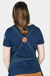 Back view of a woman wearing the Dovetail Workwear Obana Work Apron in Dark Blue Wabash Stripe, displaying cross-back straps and leather accents