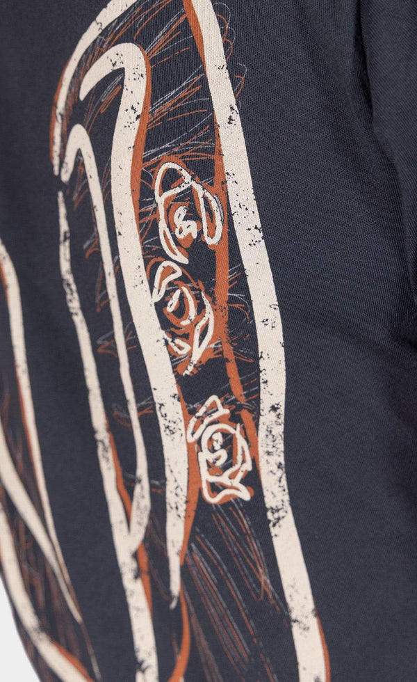 Detail view of the Rae Ripple x Dovetail Workwear Brave Wings T-Shirt in black, featuring ornate winged graphic design on the back.