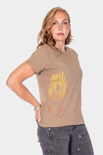 Rae Ripple x Dovetail Workwear You Will Be Art T-Shirt in Alloy Brown, shown on a woman from the side wearing the relaxed-fit cotton tee with handwritten text on the left sleeve