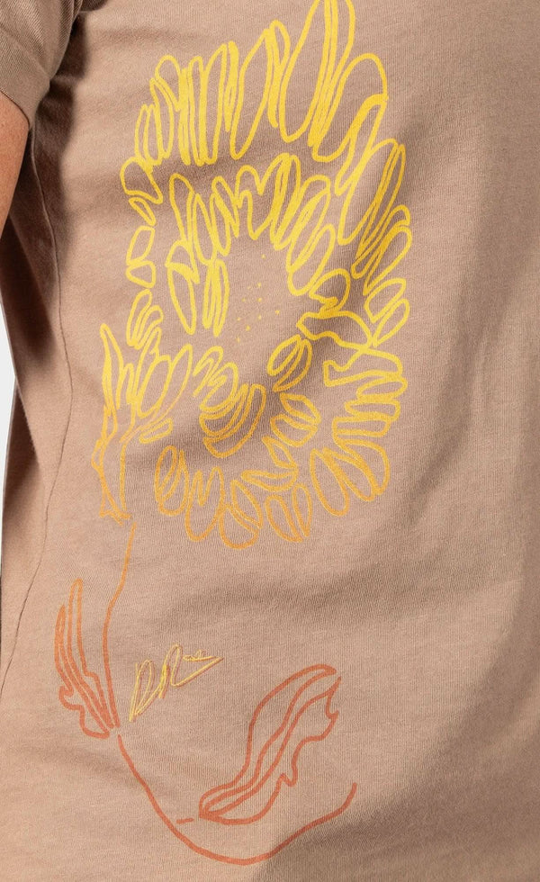 Rae Ripple x Dovetail Workwear You Will Be Art T-Shirt in Alloy Brown displays handwritten text on the left sleeve on a woman wearing the relaxed-fit cotton tee.