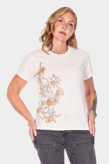 Rae Ripple x Dovetail Workwear Love Language T-Shirt in buttermilk, featuring metal flowers down the front, worn by a woman with hand on hip