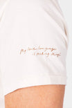 Detail view of the Rae Ripple x Dovetail Workwear Love Language T-Shirt in buttermilk, showing the handwritten "my love language is making things" text on the sleeve