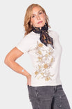 Woman wearing Rae Ripple x Dovetail Workwear Brave Wings Bandana in black tied around her neck over a floral graphic tee