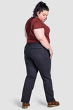 Back view of a woman wearing Dovetail Workwear's Day Construct Pant in Lightweight Dark Navy Ripstop, showing relaxed leg, reinforced knees, and functional pockets