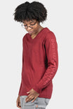 Dovetail Workwear Women's Long Sleeve V-Neck Tee in Currant, shown on a woman wearing gray jeans, featuring subtle branding down the left arm