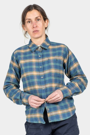 Woman wearing the Dovetail Workwear Givens Work Shirt in Vintage Blue Plaid with stretch flannel fabric, featuring a chest pocket and button-front closure