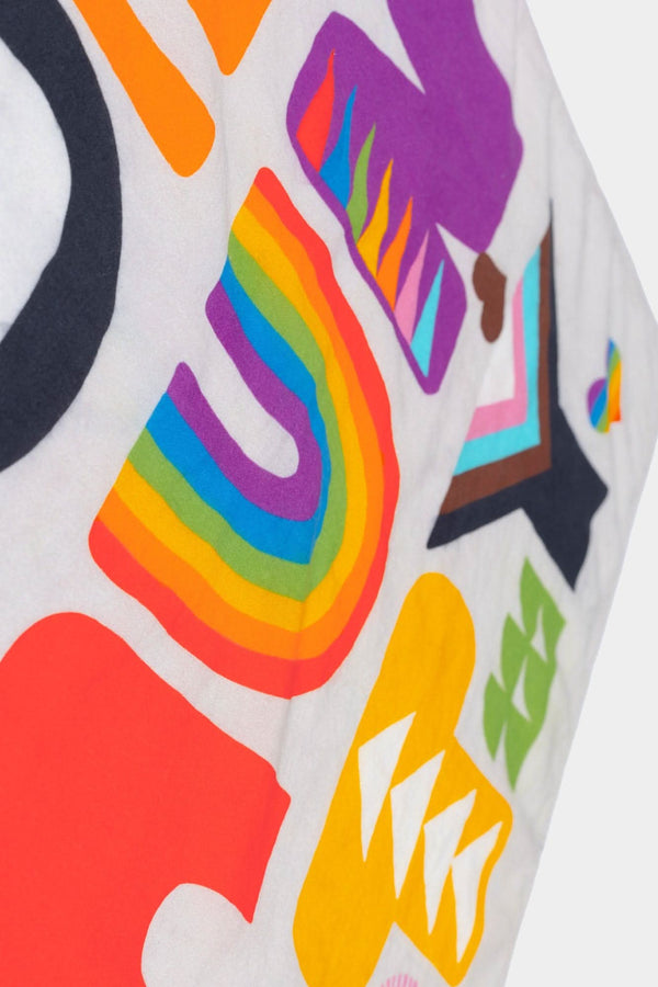 Detail view of Lisa Congdon's Pocket Pride Bandana by DoveLab™, featuring colorful rainbow stripes, geometric shapes, and pride flag-inspired designs on white fabric