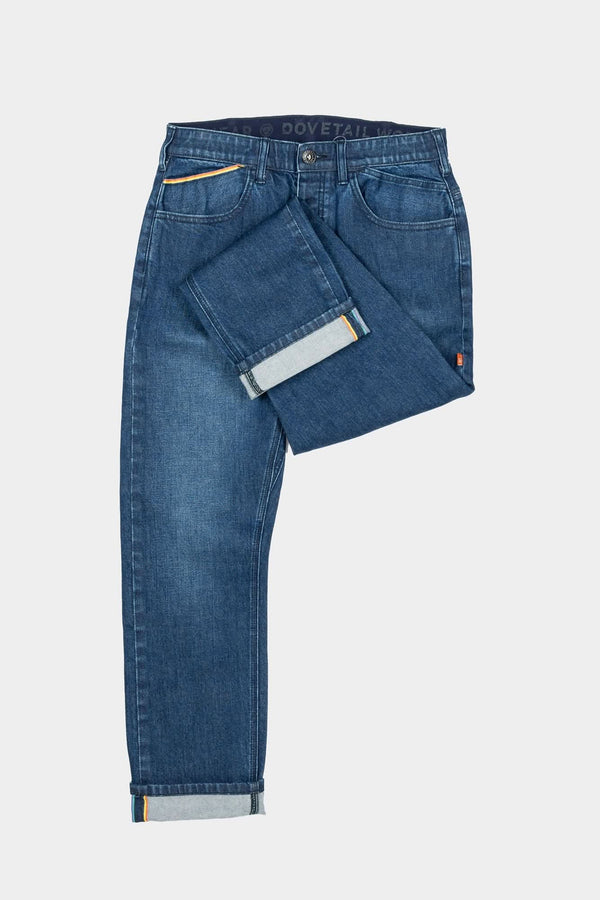 Dovetail Workwear Pride Shop Pant in Indigo Denim Blue displayed flat lay, showing rolled cuffs with selvedge detail and multiple pockets