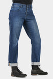 Dovetail Workwear Pride Shop Pant in Indigo Denim Blue with rolled cuffs, shown on a woman wearing black boots, featuring relaxed leg fit and visible pocket details