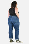 Back view of a woman wearing Dovetail Workwear's Pride Shop Pant in Indigo Denim Blue, showcasing the relaxed leg, rolled cuffs, and multiple pockets