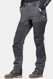 Dovetail Workwear D-Fender Pant in Cement Grey Stretch Canvas shown on a woman wearing work boots, featuring reinforced knees, crotch gusset, and relaxed leg construction
