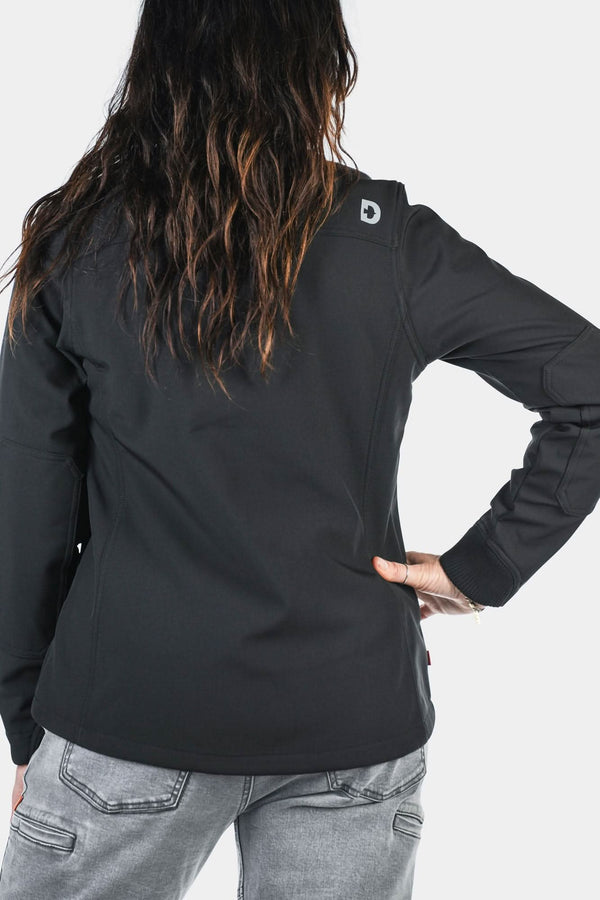 Back view of a woman wearing the M'fon Jacket in Black by Dovetail Workwear, featuring water-resistant softshell fabric and long sleeves