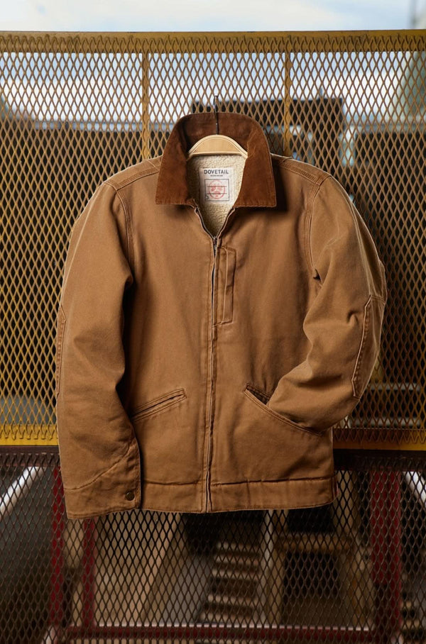 Dovetail Workwear Old School Trucker Canvas Work Jacket in Vintage Brown displayed on a hanger, showcasing the faux shearling collar, zip front closure, and deep front pockets