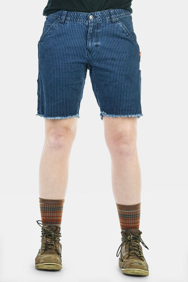 Dovetail Workwear Wabash Work Short in Wabash Stripe with frayed cuffs, shown on a woman wearing striped socks and lace-up boots