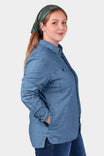 Back view of a woman wearing the John Deere X Dovetail Cultivator Work Shirt in indigo blue dobby with a green headscarf