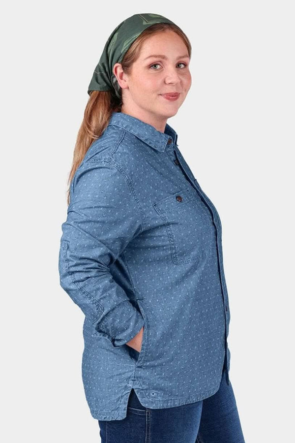 Back view of a woman wearing the John Deere X Dovetail Cultivator Work Shirt in indigo blue dobby with a green headscarf