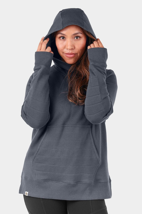 John Deere X Dovetail Workwear Early Bird Hoodie in Steel Grey, shown on a woman wearing the cowl neck hoodie with thumbholes and ponytail slit pulled up over her head