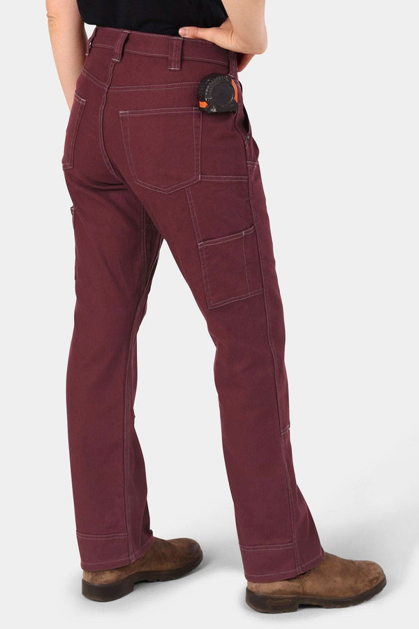 Back view of a woman wearing the Anna Taskpant in Elderberry Canvas by Dovetail Workwear, featuring multiple pockets, a relaxed leg fit, and visible Hip Slot™ Tool loop at the waist