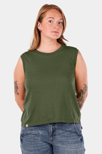 Dovetail Workwear Bellows Work Tank Top in Blade Green, displayed on a woman wearing the loose-fit sleeveless tank with visible back pleating for breathability and mobility