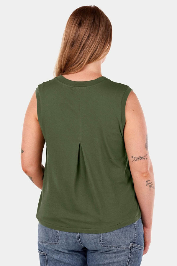 Back view of a woman wearing the Dovetail Workwear Bellows Work Tank Top in Blade Green, displaying the longer back length and breathable back pleat design