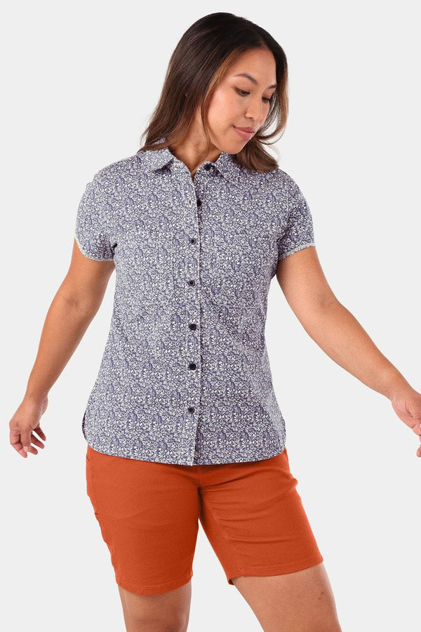 Woman wearing the Carver Work Shirt by Dovetail Workwear in Navy with short sleeves and button front, paired with orange shorts