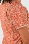 Detail shot of the Dovetail Workwear Carver Work Shirt in Paprika, showcasing the paisley print and short sleeve with contrasting trim on a woman