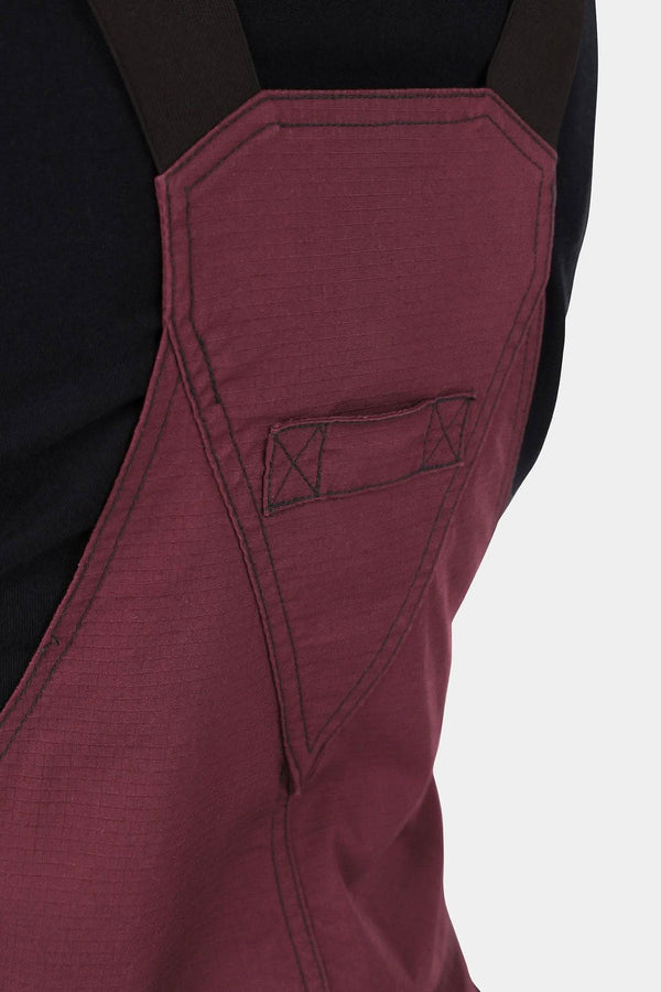 Detail view of the Elderberry Maroon Freshley Overalls in Ultralight Ripstop by Dovetail Workwear, highlighting the kneepad slot and reinforced stitching on the leg
